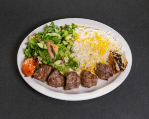 Mediterranean beef shish kabob with grilled tomato, fresh salad and basmati rice at Jasmine Grill & Cafe