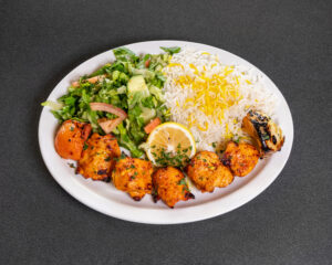 Mediterranean boneless chicken kabob plate with basmati rice and grilled tomato at Jasmine Grill & Cafe