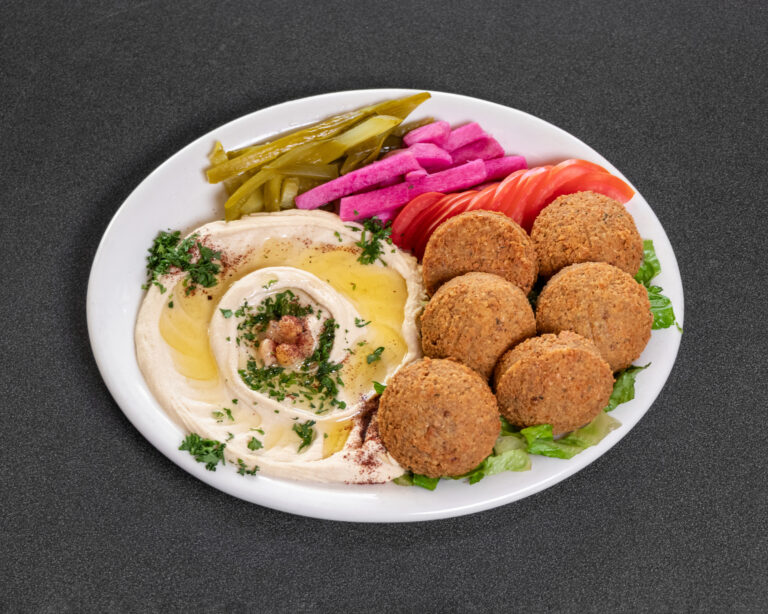 Mediterranean falafel and hummus plate with pickles and fresh vegetables at Jasmine Grill & Cafe