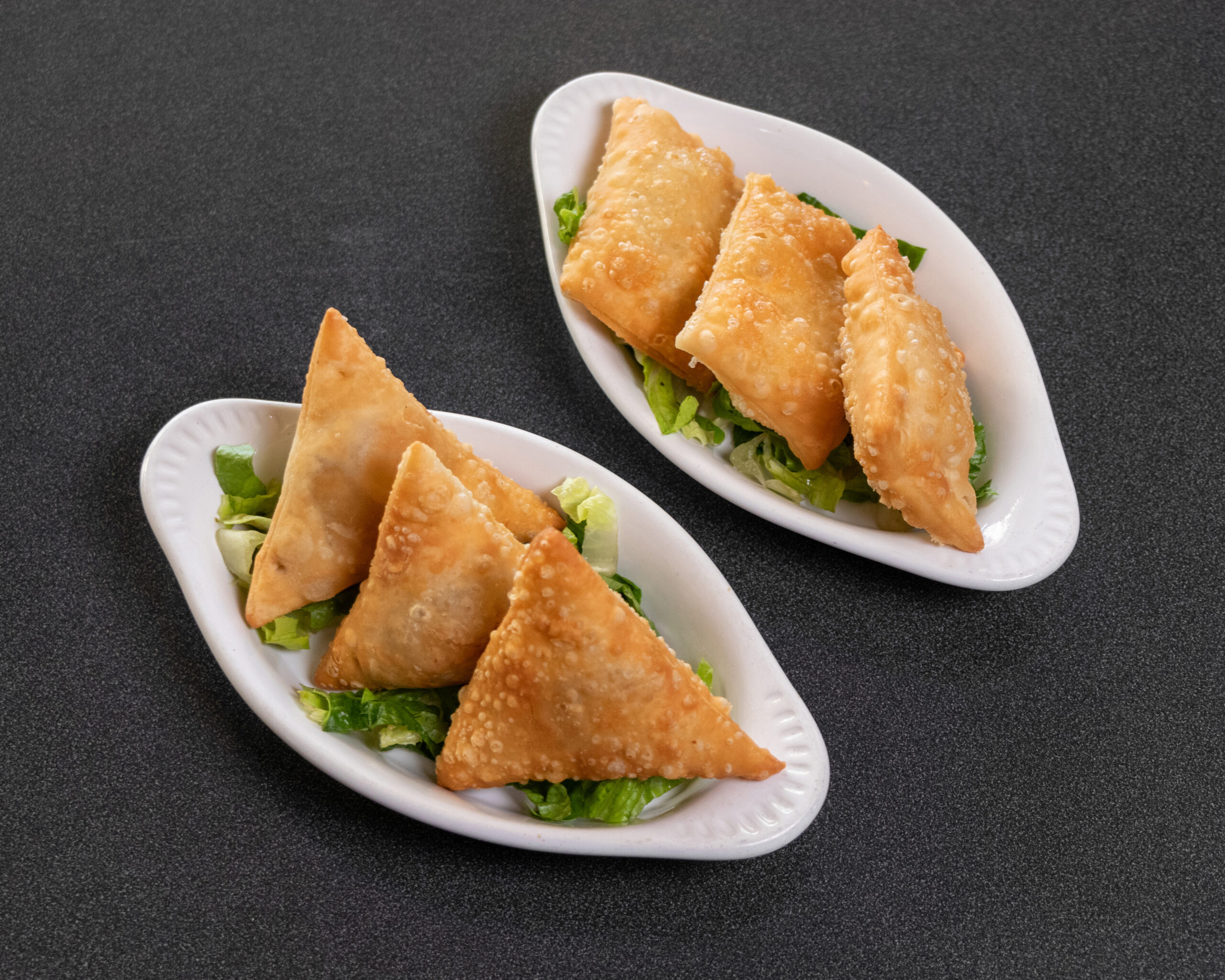 Mediterranean beef and cheese sambousek pastries served as an appetizer at Jasmine Grill & Cafe
